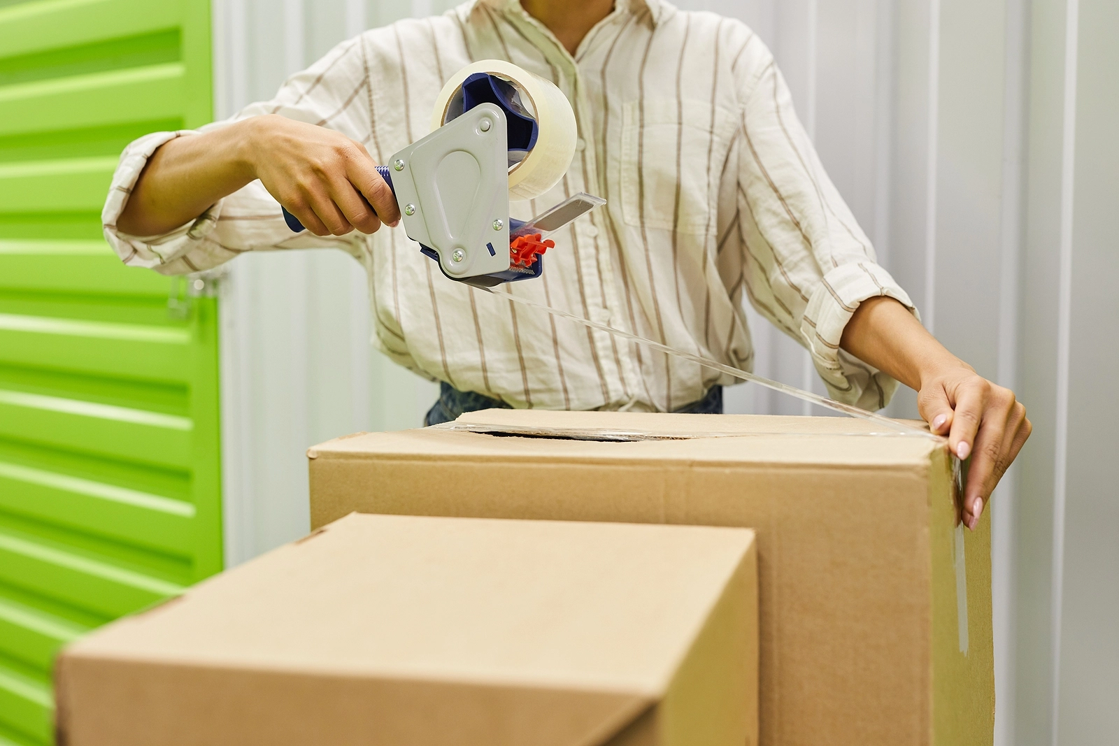 Cropped Portrait Of Unrecognizable Young Woman Packing Boxes Wit