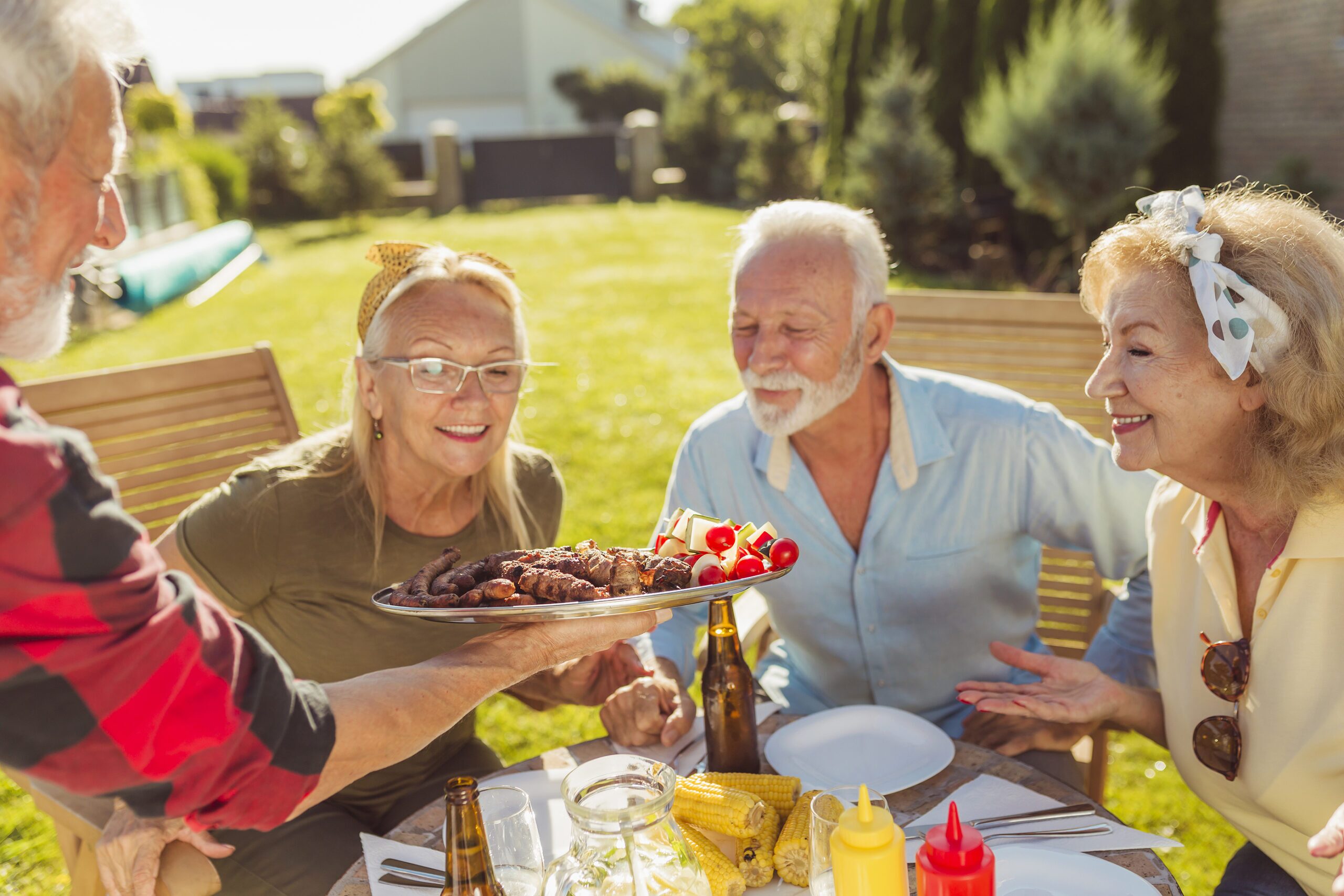 Group Of Cheerful Senior Friends Having An Outdoor Lunch In The